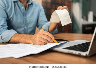 man-filling-out-tax-forms-260nw-2566538987