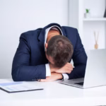 tired-employee-working-desk-company-office_118454-10266