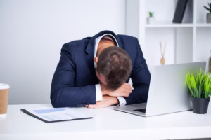 tired-employee-working-desk-company-office_118454-10266