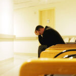 "Man sits alone, worried and waiting for his destiny to unfold."