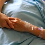 patient-s-hands-or-arm-giving-the-saline-solution-on-bed-with-copy-space-healthy-medicine-or-medical-and-injection-people-cure-sickness-and-fever-at-hospital-or-clinic-concept-free-photo