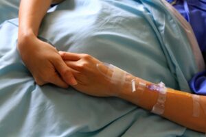 patient-s-hands-or-arm-giving-the-saline-solution-on-bed-with-copy-space-healthy-medicine-or-medical-and-injection-people-cure-sickness-and-fever-at-hospital-or-clinic-concept-free-photo