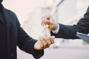 buying-property-concept-man-uniform-giving-keys-black-man_1157-50916