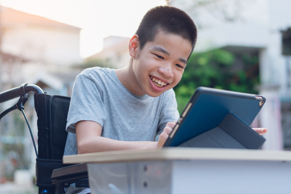 Disabled,Child,On,Wheelchair,Happy,Time,To,Use,A,Tablet